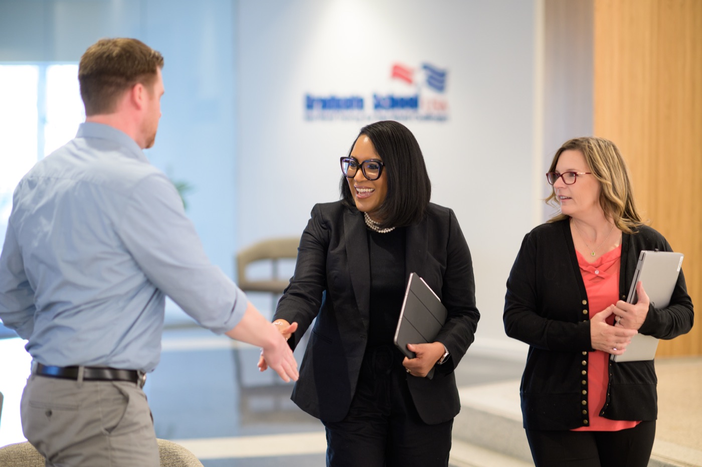 Graduate School USA staff welcoming colleagues in the office